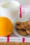Breakfast tray: cookies, milk and orange