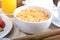 Breakfast tray with orange juice, cereals and fruits.