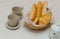 Breakfast two cups a teapot with a fresh bread basket with French baguettes donuts