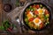 Breakfast for two. Fried eggs with vegetables - shakshuka in a frying pan