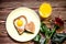 Breakfast Valentine`s Day. On the plate is toast with fried eggs inside a heart. Next on the plate is a little toast in the form o