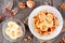 Breakfast waffle with bananas and walnuts, above view table scene over wood