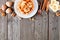 Breakfast waffle with bananas and walnuts, above view top border with copy space over wood