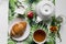 Breakfast in white dishes on a colored tablecloth with a croissant