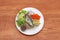 Breakfast in the white round plate on wooden floor. Fried mackerel and Rice with Spicy Shrimp Paste Dip and vegetable, Chinese