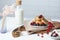 Breakfast on a white table, pancakes with berries, fresh cottage cheese and a bottle of milk