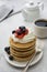 Breakfast wih Pancakes, cream, berry and coffee cup isolated on white background, copy space for text