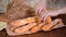 Breaking a baguette. Hands of woman breaking baked bread in half. Woman hands breaking crispy french baguette.