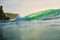 Breaking green wave in ocean. Perfect wave and evening light