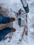 Breaking through ice on sidewalk with shovel during cold weather