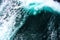 Breaking turquoise wave, splashing water drops, rough sea, very sharp photo