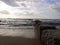 Breaking waves at Westerland beach on Sylt island. National Park Wattenmeer panorama at sunset with colorful cloudy sky