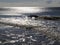 Breaking waves at Westerland beach on Sylt island. National Park Wattenmeer panorama at sunset with colorful cloudy sky