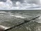 Breaking waves on a wooden breakwater on the Baltic Sea coast.