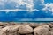 Breakwater with Cumulus Clouds and Torrential Rain over The Sea