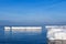 The breakwater in the form of an iceberg in a Sunny winter day.