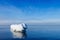 The breakwater in the form of an iceberg in a Sunny winter day.