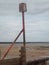Breakwater groyne  with red marker post