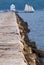 Breakwater Leads to Lighthouse as Schooner Sailing Vessel Passes