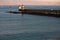 Breakwater with lighthouses in sunrise on atlantic ocean