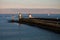 Breakwater with lighthouses in sunrise on atlantic ocean