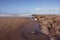 Breakwater at low tide with view on the northsea