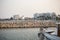 Breakwater of rocks at Cyprus, Larnaca. Summer destination. Beach, sea, town, blue sky background.