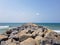 Breakwater rocks overlooking the atlantic ocean. Wave barrier, coastal fortification and protection structure.