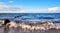 Breakwater with seagulls in the Baltic Sea. In the background the harbor of Glowe. Mecklenburg-Vorpommern