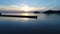 Breakwater of stone in the sunset sea