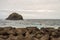 Breakwater wall with a small island at a mausade temp on the coast