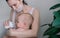 Breastfeeding baby eating milk from mothers breast and bottle. Concept - breastfeeding and motherhood