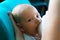 Breastfeeding baby, portrait of cute newborn face getting milk