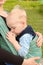 Breastfeeding in baby sling outdoors