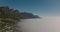 Breath taking footage of mountains rising from landscape flooded by fog. Morning mist above sea coast. Cape Town, South