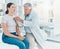 Breathe in and out for me. a doctor listening to a patients heartbeat using a stethoscope.