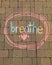 Breathe written in rainbow chalk