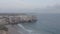 Breathtaking aerial drone view of Lagos Algarve rocky cliff coastline, waves crashing against shore, sideway flight