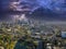 a breathtaking aerial shot of downtown Los Angeles with skyscrapers lush green trees, small buildings and homes