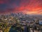 A breathtaking aerial shot of downtown Los Angeles with skyscrapers lush green trees, small buildings and homes