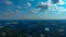 A breathtaking aerial shot of vast miles of trees and buildings with a gorgeous blue sky and powerful clouds at at Duncan Park