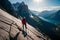 A breathtaking aerial view of a climber perched on a steep rock face, overlooking a rugged mountain landscape