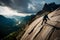 A breathtaking aerial view of a climber perched on a steep rock face, overlooking a rugged mountain landscape