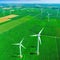 A breathtaking aerial view of lush green fields with a backdrop of orderly windmills generating renewable
