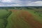 Breathtaking beautiful aerial view of a poppy field growing among rapeseed. Aerial view of the drone from above.