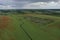 Breathtaking beautiful aerial view of a poppy field growing among rapeseed. Aerial view of the drone from above.