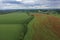 Breathtaking beautiful aerial view of a poppy field growing among rapeseed. Aerial view of the drone from above.