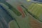 Breathtaking beautiful aerial view of poppy flowers in rapeseed and wheat field. Aerial view of the drone from above.