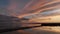 Breathtaking colorful sunset cloudscape over Powder Point Bridge on Duxbury Bay in dark evening