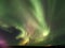 Breathtaking green and pink Aurora Borealis flashing on the night sky